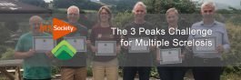 the 3 peaks team stand for a photo with certificate